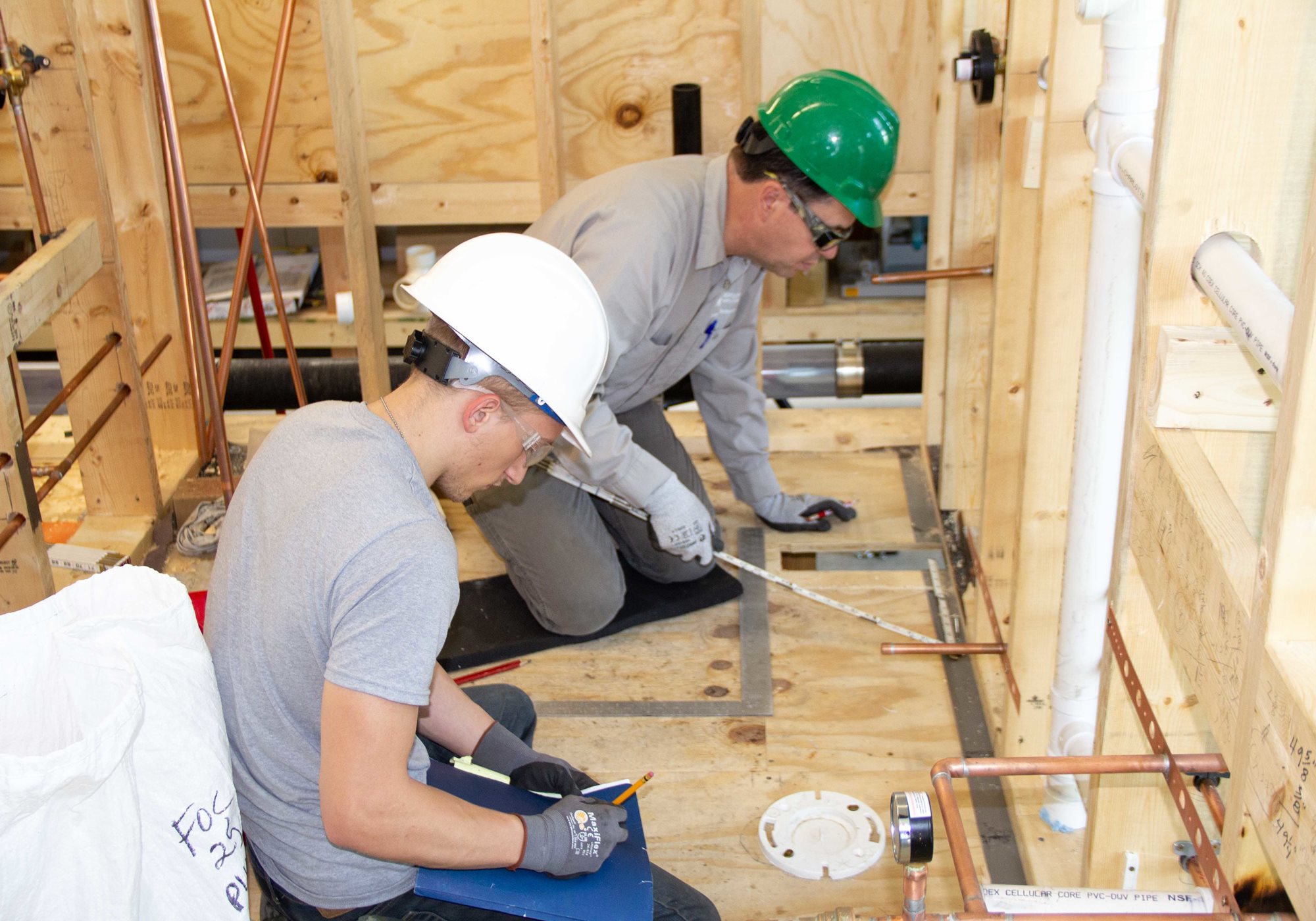 Two floor installers working on floor installation