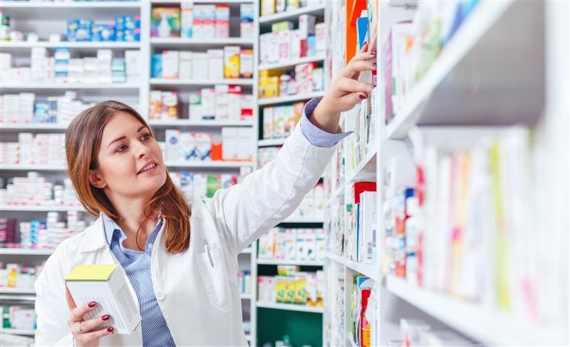 Pharmacy Technician Browsing Through Shelf