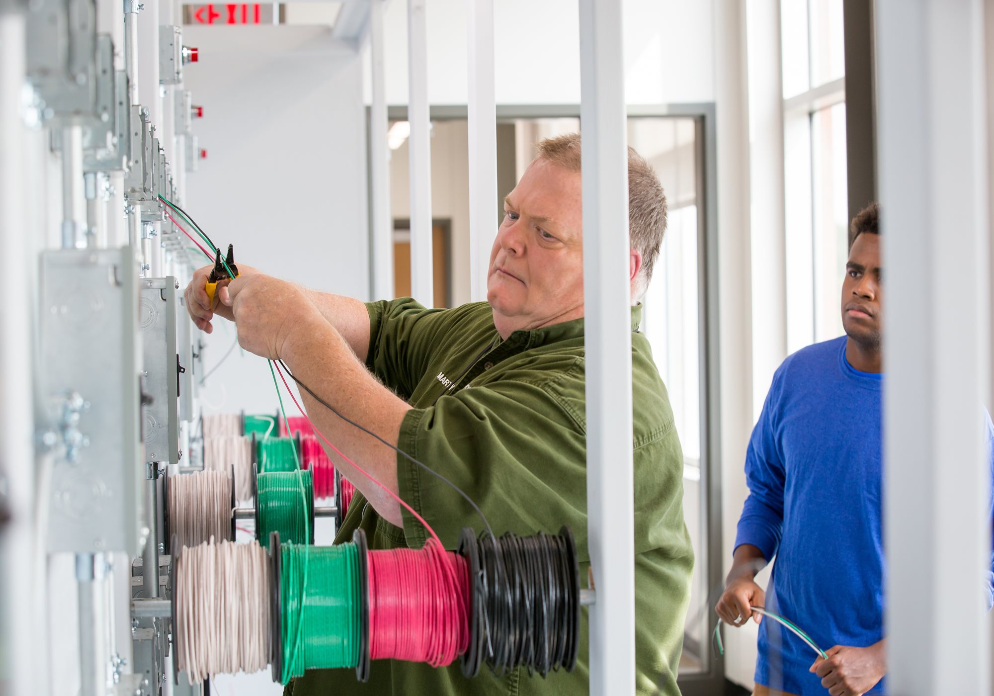 Instructor instructing a student on electrical wiring