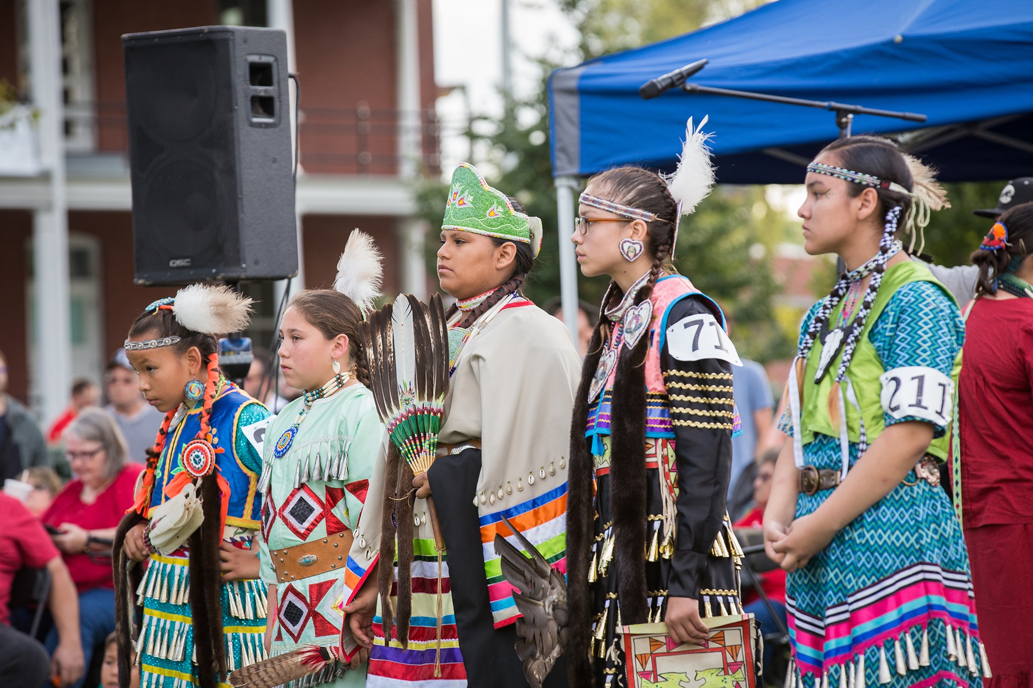 Five young women dressed in Native American regalia