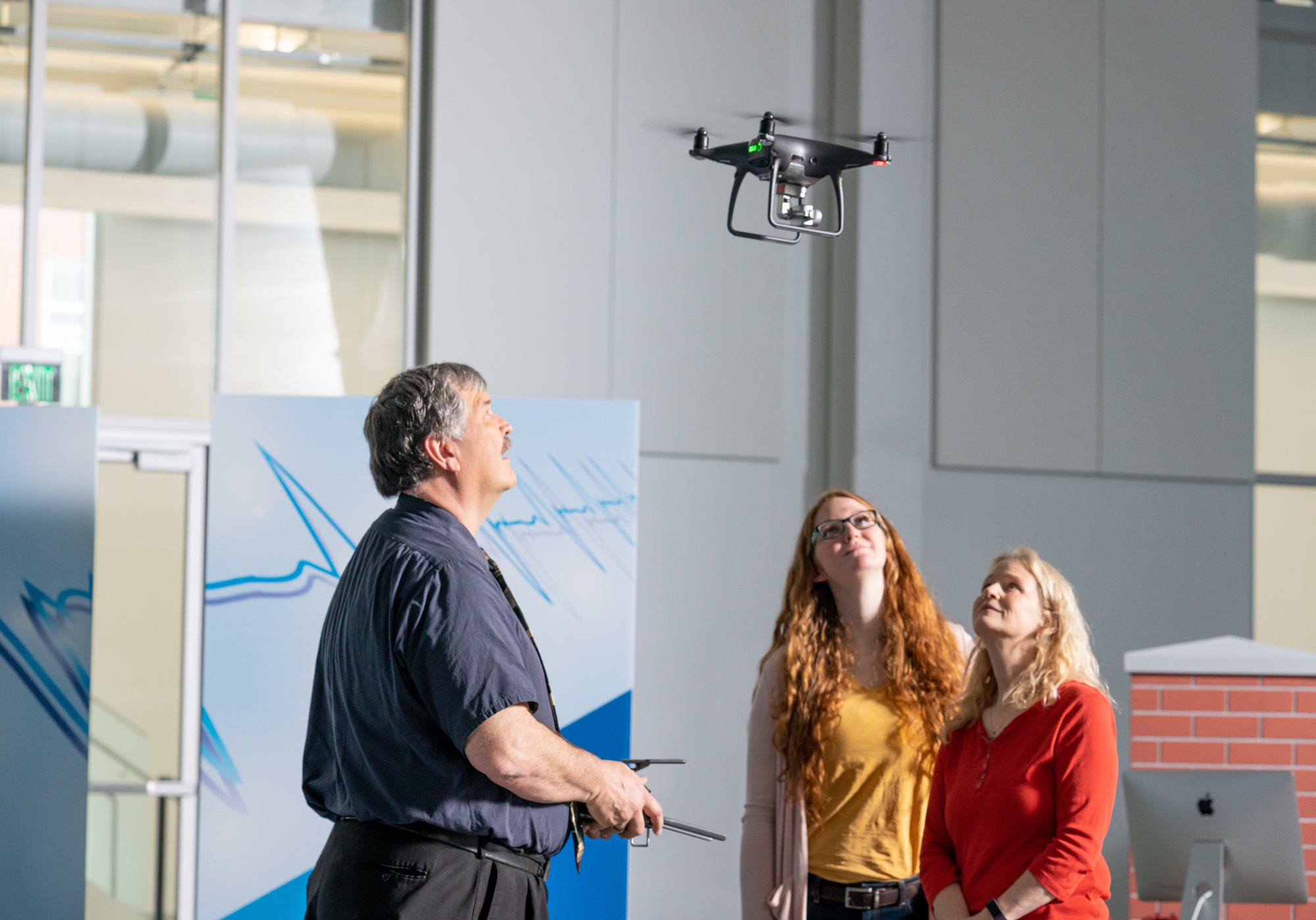 Instructor Operating Drone in front of Students