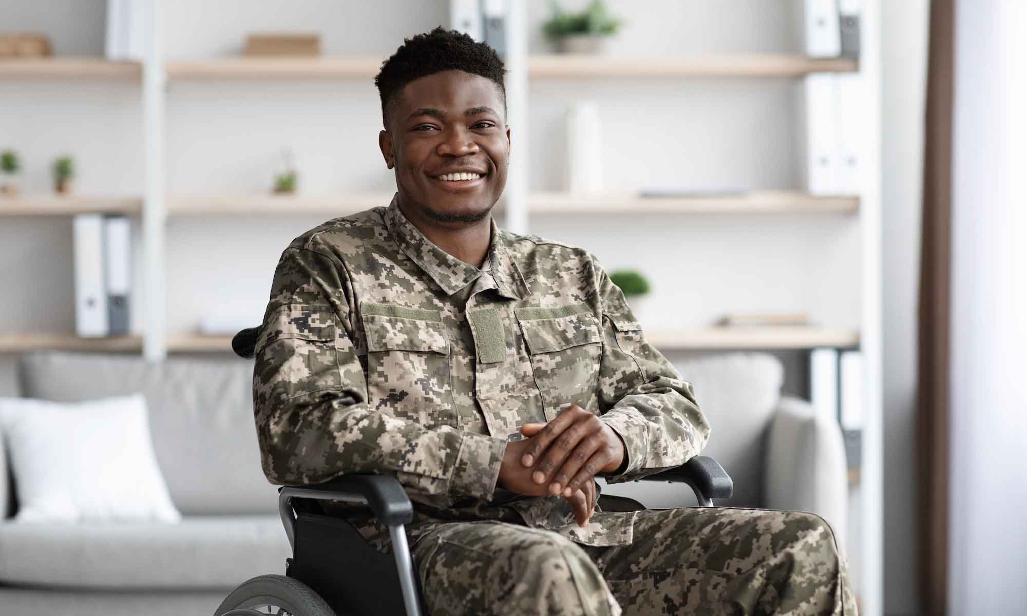 Happy military person sitting in wheelchair