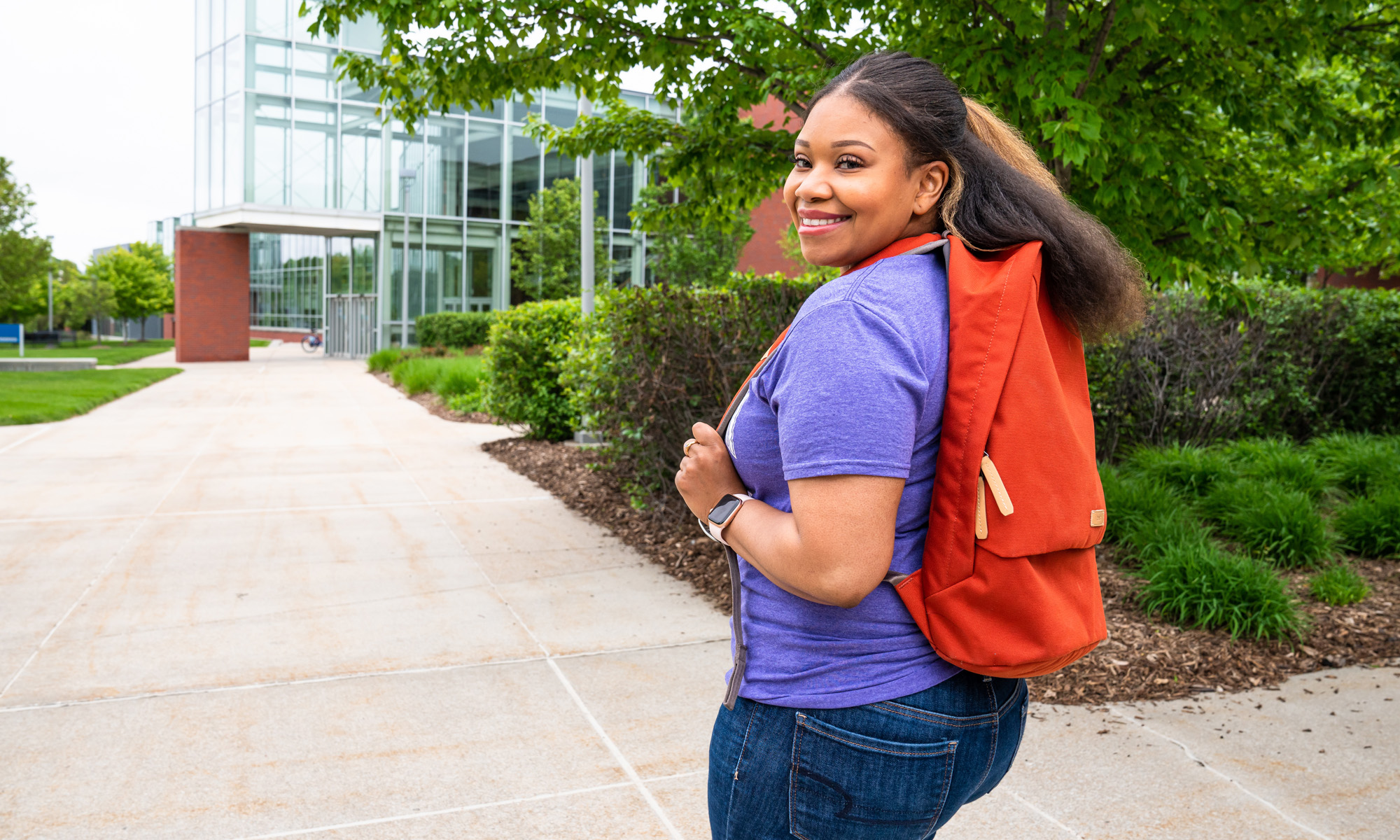 Happy female student walking the school grounds