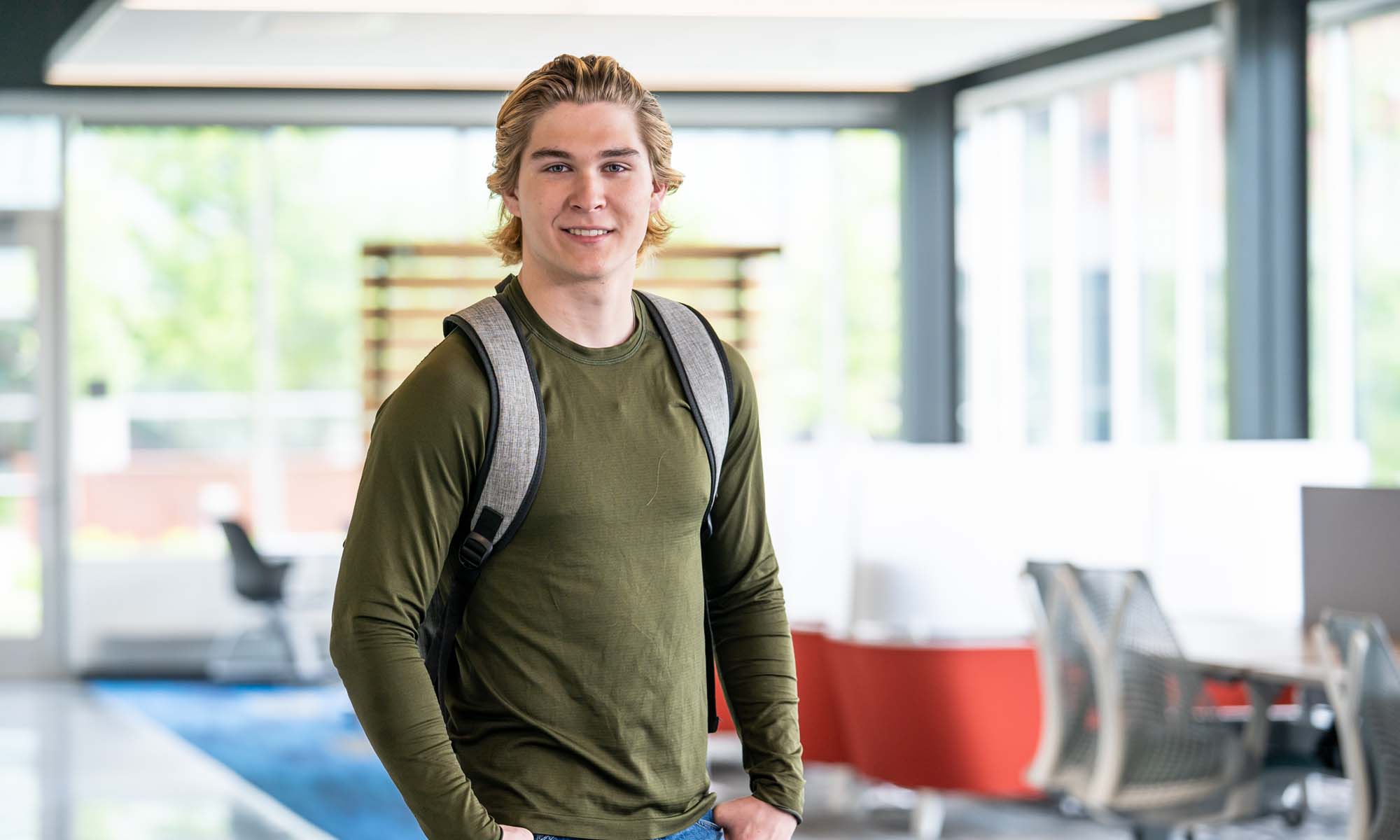 Happy male student in hallways